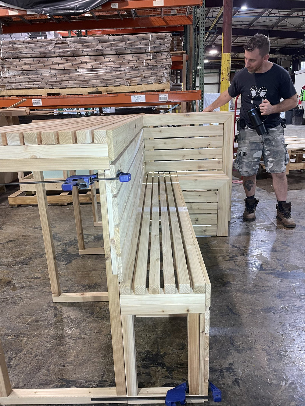 A craftsman assembling tiered sauna benches in the workshop