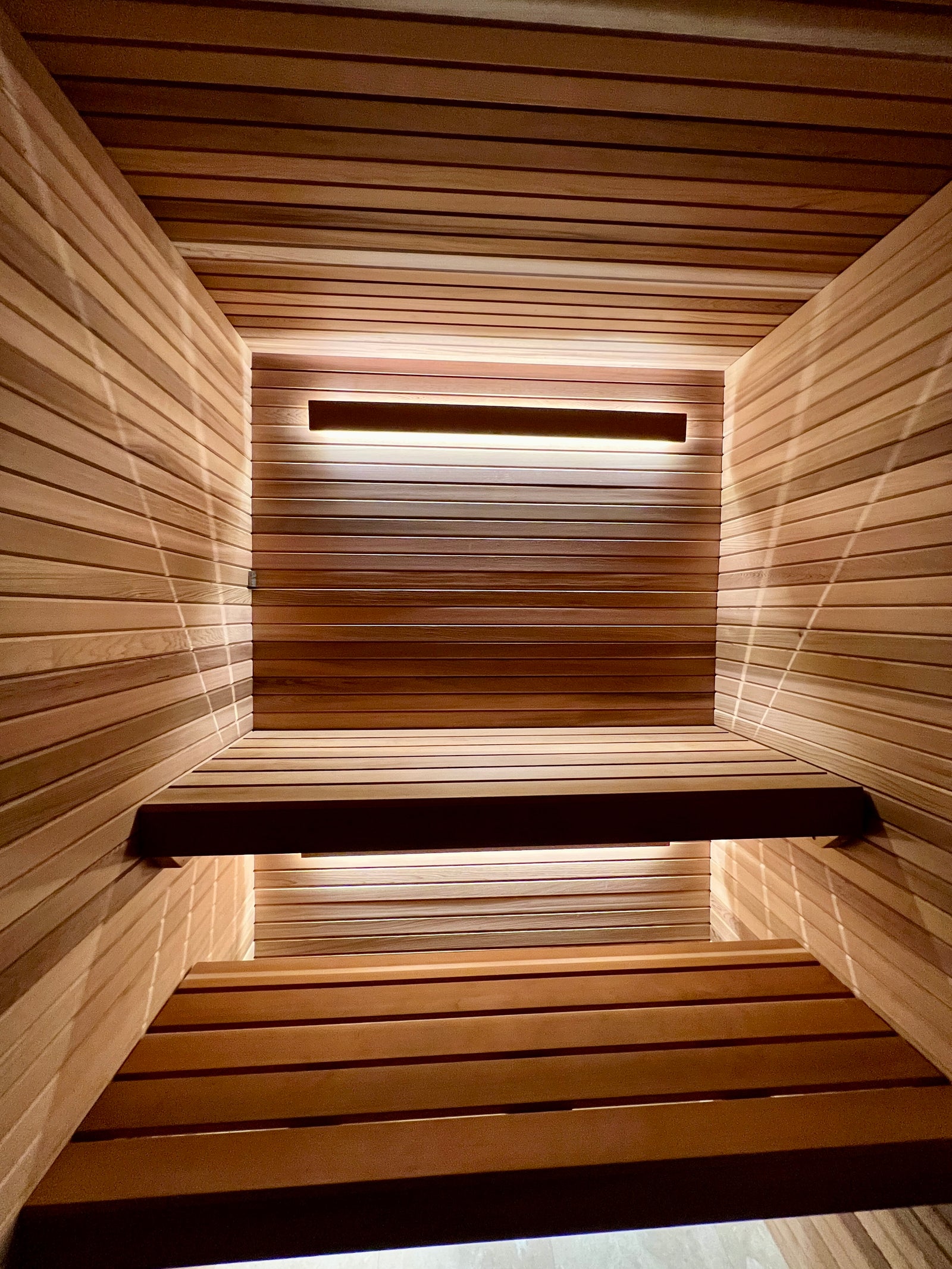 Modern minimalist sauna interior with clean lines and warm lighting