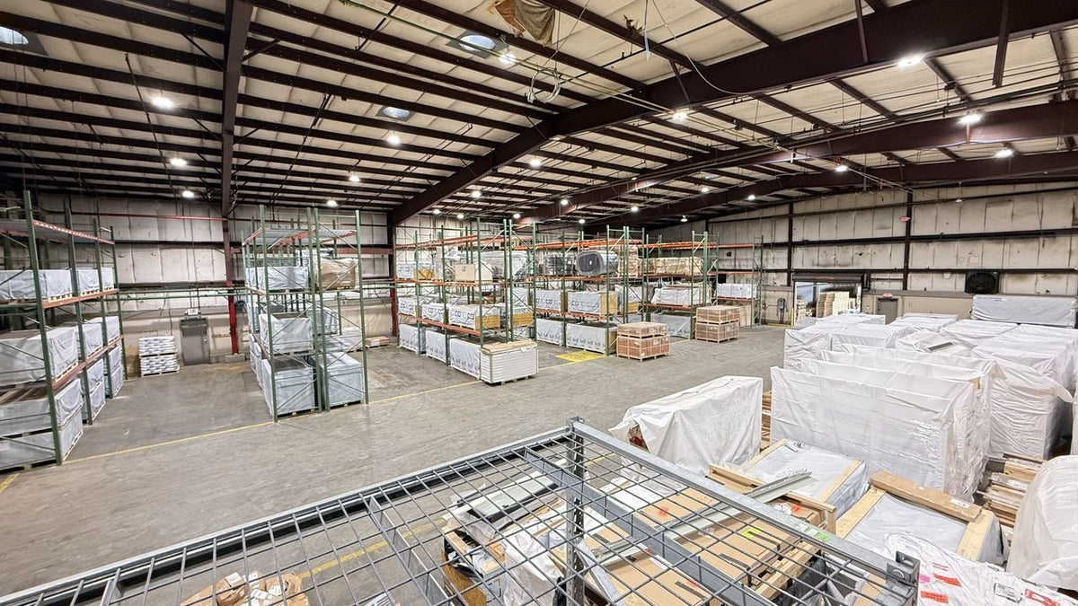 Pallet racks of wrapped saunas and boxed inventory in our Cookeville warehouse